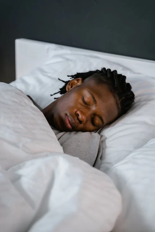 “Young man sleeping soundly in a calm bedroom, evoking natural and restful sleep