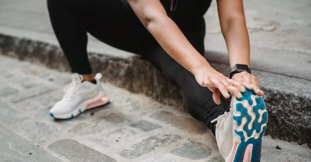 A woman in athletic apparel stretching on an urban sidewalk for fitness and flexibility.